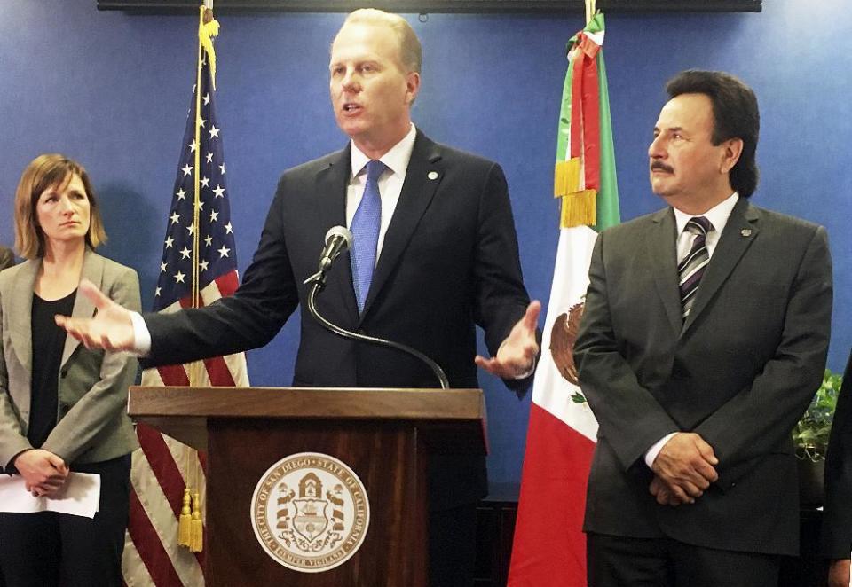 San Diego Mayor Kevin Faulconer, left, and Tijuana, Mexico, Mayor Juan Manuel Gastelum discuss the benefits of cross-border ties at a news conference at San Diego City Hall, Monday, Feb. 6, 2017. The mayors of the largest metropolitan area on the U.S.-Mexico border called for stronger binational ties, striking a sharp contrast with U.S. President Donald Trump's calls to build a wall and renegotiate the North American Free Trade Agreement. (AP Photo/Elliot Spagat)