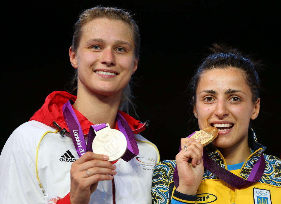LONDON, ENGLAND - JULY 30: Silver medal winner Britta Heidemann (L) of Germany, and Gold medal winner Yana Shemyakina (R) of Ukraine pose after the Women's Epee Individual Fencing Finals on Day 3 of the London 2012 Olympic Games at ExCeL on July 30, 2012 in London, England. (Photo by Hannah Johnston/Getty Images)