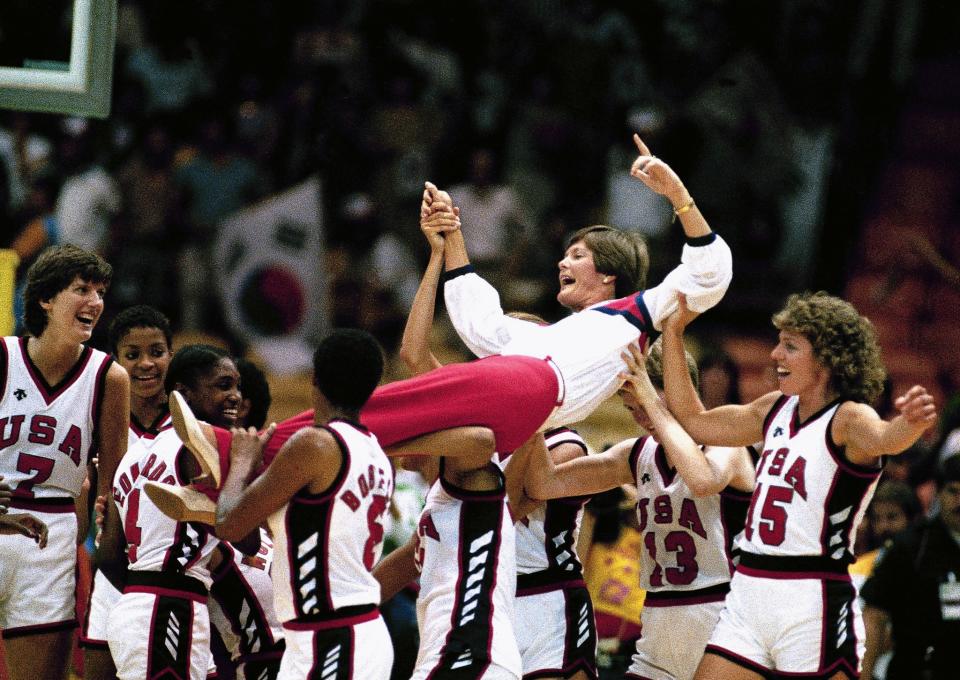 U.S. women's basketball coach Pat Summitt is carried off by members of the team following their 85-55 win over South Korea in the gold medal game in the Olympics in Los Angeles. (AP)