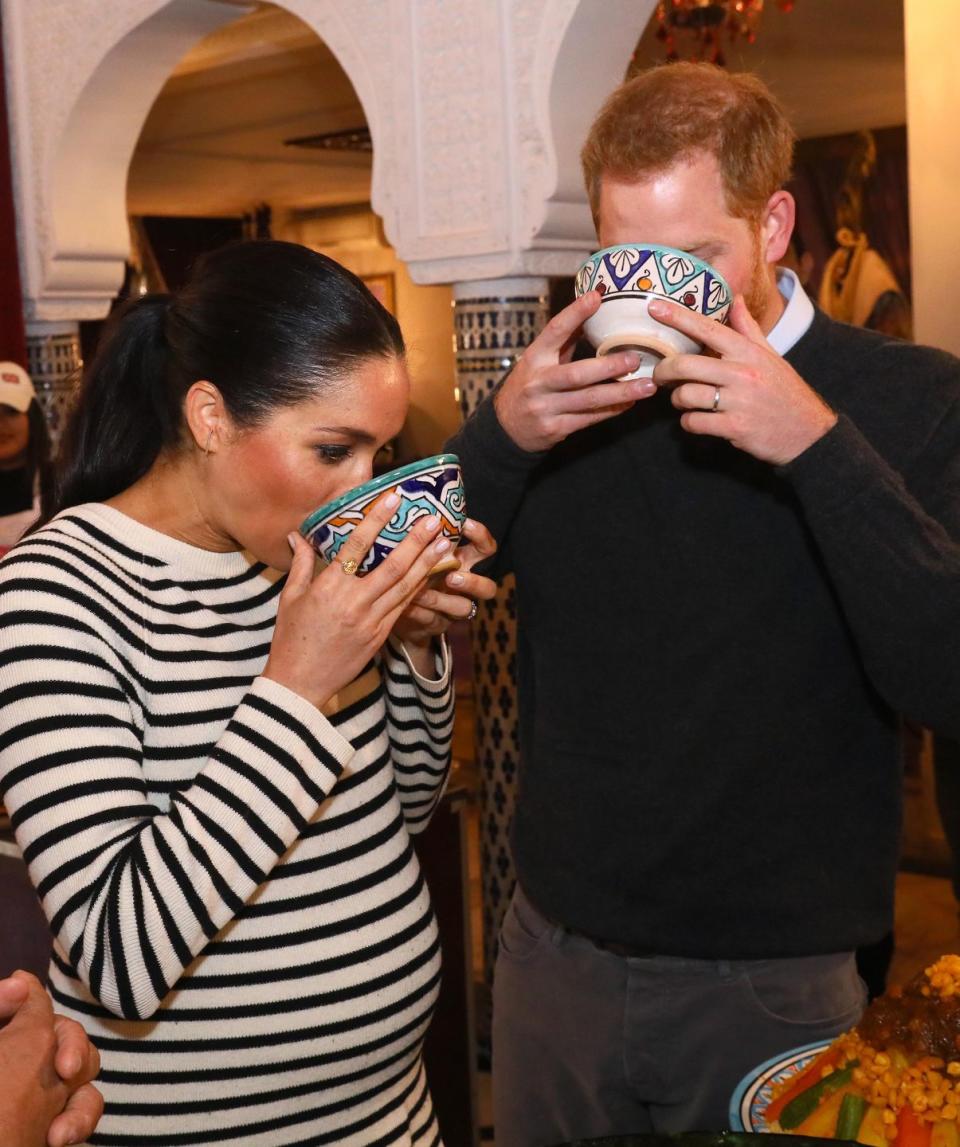 <p>While at a cooking demonstration in Morocco in 2018, Prince Harry and a pregnant Meghan Markle proved that no one looks elegant while sipping from a big mug. The couple sampled a number of different cuisines throughout the day, which was part of their last tour before the birth of their son in May 2018. </p>