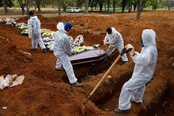 Cemetery workers in protective suits bury a victim of coronavirus at the Vila Formosa cemetery in Sao Paulo, Brazil.