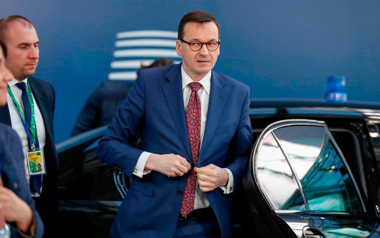 Mateusz Morawiecki, pictured in Brussels in 2019, said that his Law and Justice party supports climate action in Poland but not if its targets are 'against the will of Poles' - Alastair Grant/AFP