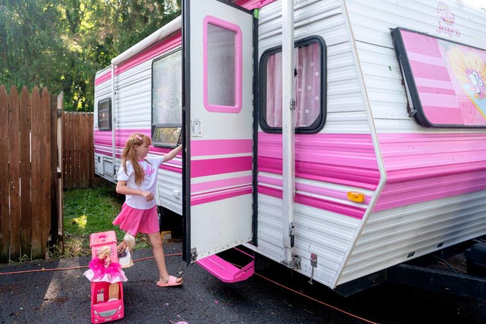 Jazmyn “Jazzy” Krammes opens the door for her real life Barbie camper on Friday, July 14, 2023. Abby Drey/adrey@centredaily.com