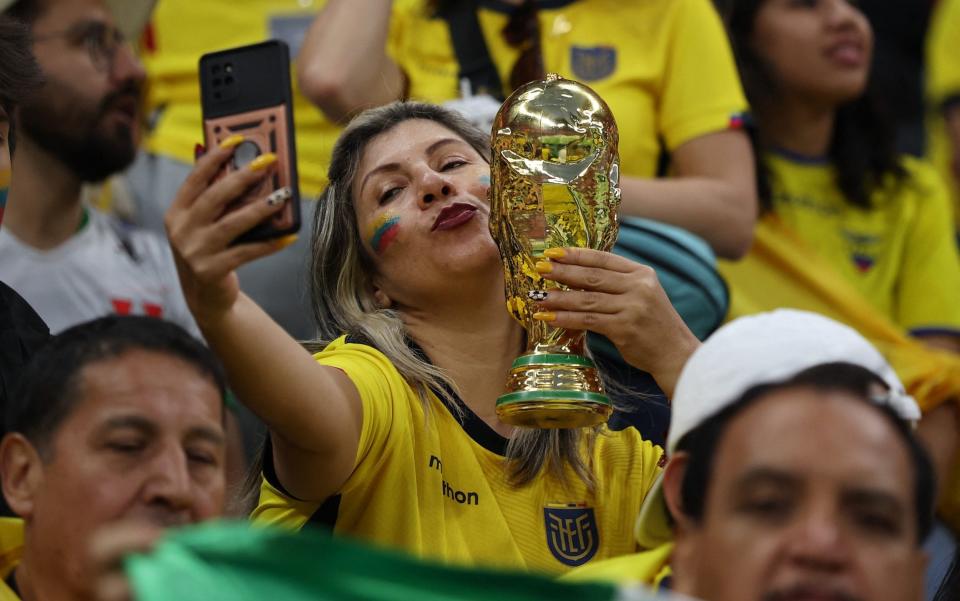 An Ecuador fan holds a replica of the world cup inside the stadium before the match - Reuters/Kim Hong-ji