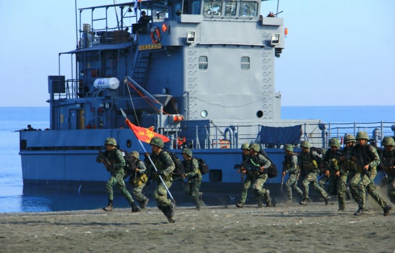 Philippine Marines take position during a beach landing as part of annual joint US and Philippine military exercises