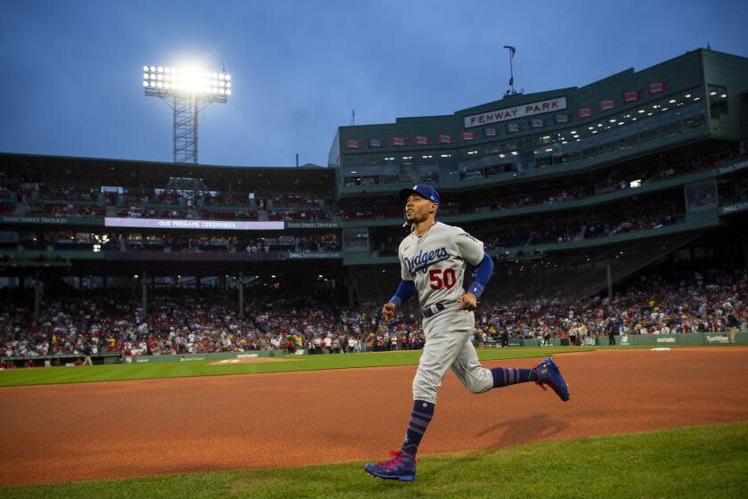 BOSTON, MA - AUGUST 25: Mookie Betts #50 of the Los Angeles Dodgers warms up.