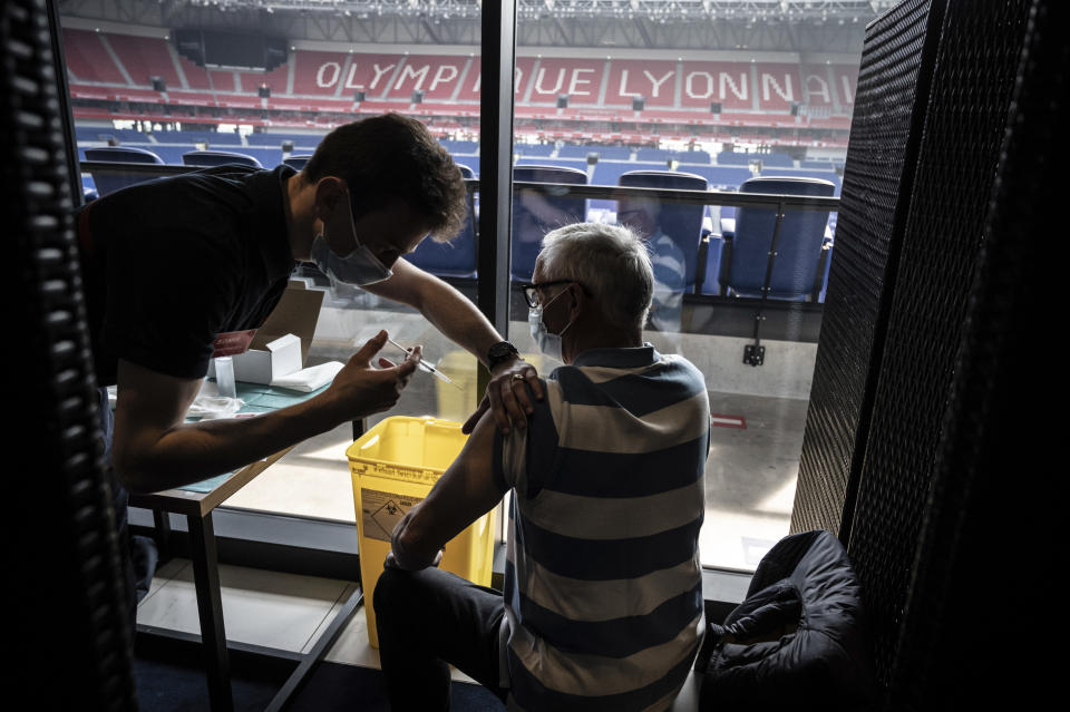 Patients receive an injection of the Moderna Covid-19 vaccine on the opening day of a mass vaccination centre set up in the Olympique Lyonnais soccer Stadium, in Decines-Charpieu, Saturday, April 3, 2021. (Jean-Philippe Ksiazek, Pool via AP)