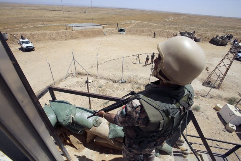 A Jordanian soldier stands guard in Mafraq, Jordan, near the northern Jordan-Syrian border, Sunday, Aug. 16, 2015. During an interview with The Associated Press, the commander of Jordan's border police said that militants from Syria are trying to blend into crowds of refugees fleeing the country's grinding civil war. (AP Photo/Raad Adayleh)