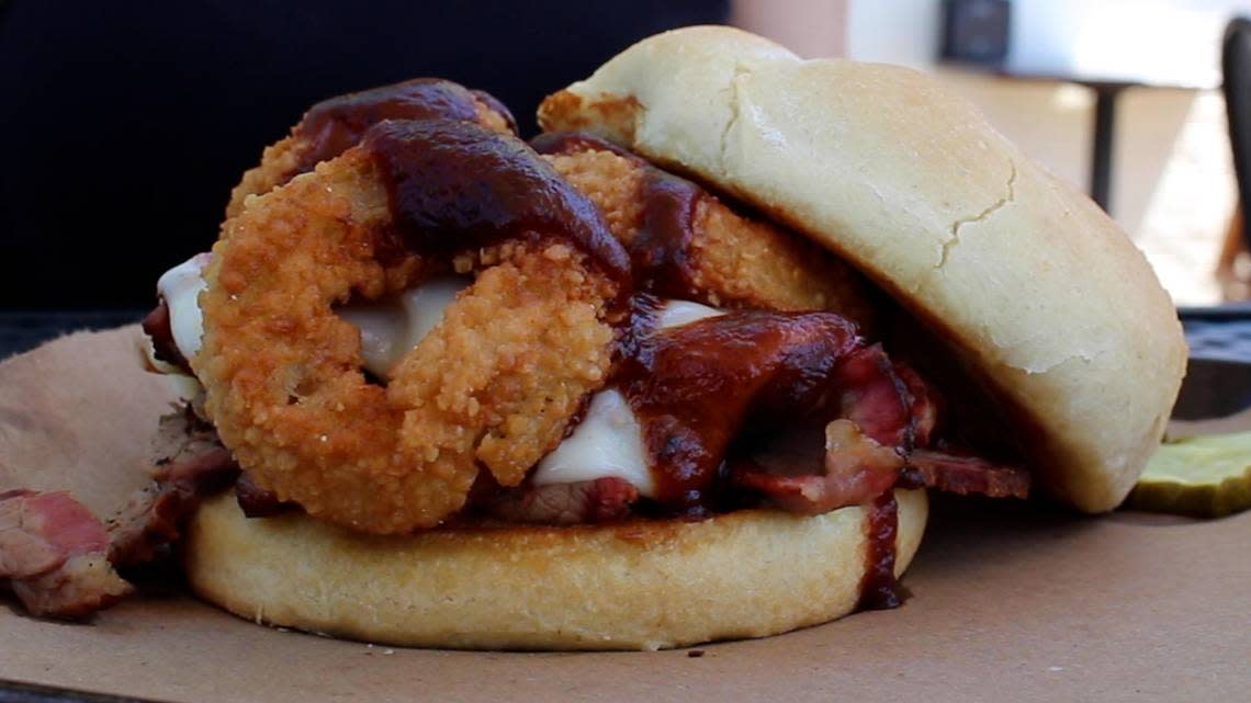 The Z-Man sandwich at Joe’s Kansas City Bar-B-Que is a brisket sandwich topped with provolone cheese, onion rings and barbecue sauce.