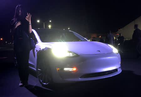 Customer employees receive some of the first Model 3 cars off the Fremont factory's production line during an event at the company's facilities in Fremont, California, U.S., July 28, 2017. REUTERS/Alexandria Sage