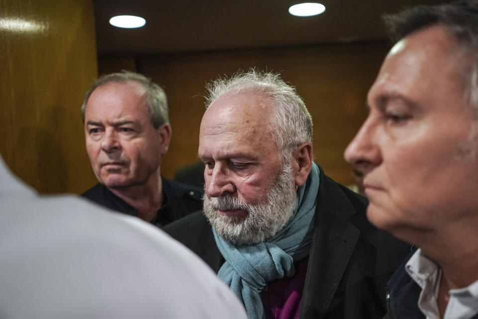 Former French priest Bernard Preynat, center, arrives at the Lyon court house, central France, Monday Jan.13, 2020. Bernard Preynat, is accused of sexually abusing some 75 Boy Scouts went on trial Monday _ but the proceedings were delayed until Tuesday because of a strike by lawyers. Preynat admitted in the 1990s to abusing boys, but was only removed from the priesthood last year. (AP Photo/Laurent Cipriani)