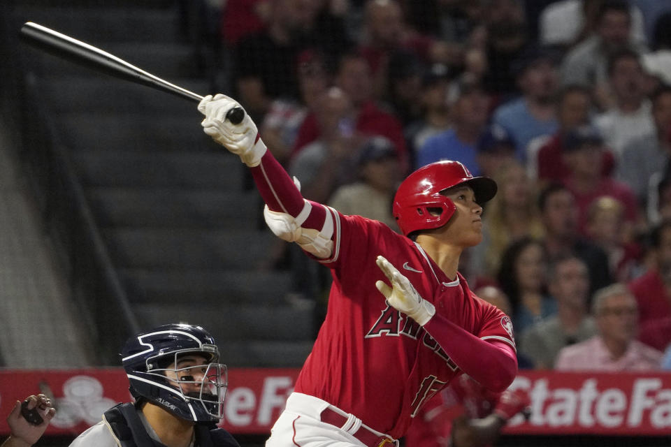 Los Angeles Angels' Shohei Ohtani, right, hits a two-run home run as New York Yankees catcher Jose Trevino watches during the fifth inning of a baseball game Monday, Aug. 29, 2022, in Anaheim, Calif. (AP Photo/Mark J. Terrill)