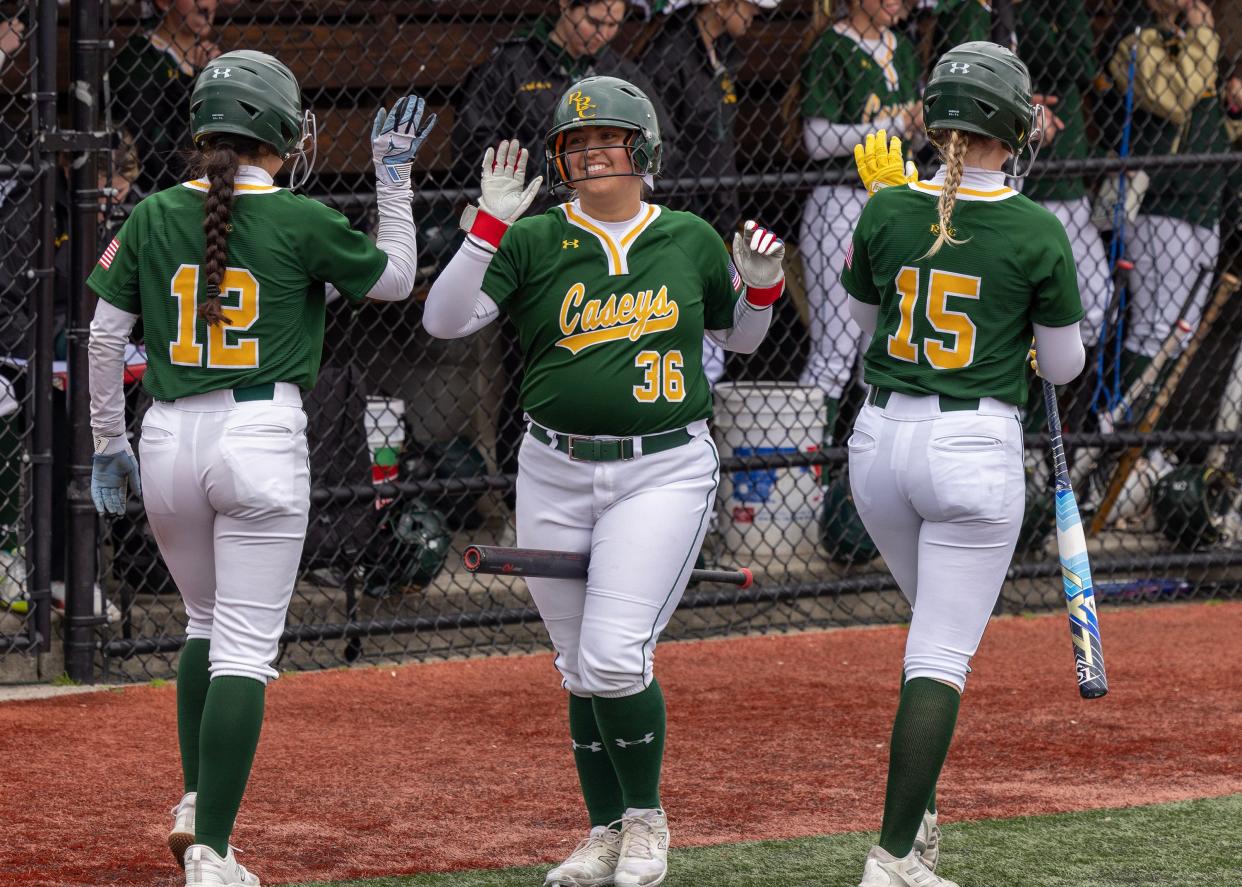 Nicole Knox and Brianna Santagelo gets high fives from Jordan Terefenko after scoring in the fourth inning. Red Bank Catholic Girls Softball defeats Wall 6-2 in home game on April 4, 2024