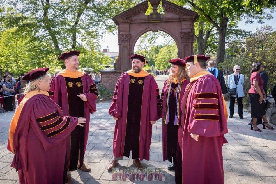 Ramapo College's first doctoral candidates wear robes they designed during the traditional "arching" walk symbolizing the end of their academic journey.  Receiving their Doctor of Nursing Practice degrees Thursday are Mary Ann Hozak, Joseph Scarano, Shaun Frame, Ruth Harrell, and Patrick Dwyer.
