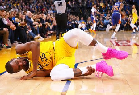 Mar 10, 2019; Oakland, CA, USA; Golden State Warriors forward Kevin Durant (35) reacts to an injured right ankle during the fourth quarter against the Phoenix Suns at Oracle Arena. Mandatory Credit: Kelley L Cox-USA TODAY Sports