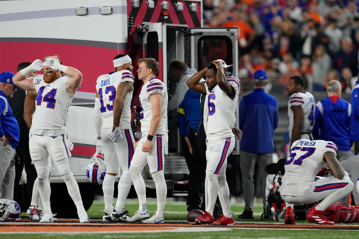 Mandatory Credit: Photo by Jeff Dean/AP/Shutterstock (13692270bl) Buffalo Bills players react as teammate Damar Hamlin is examined during the first half of an NFL football game against the Cincinnati Bengals, in Cincinnati Bills Bengals Football, Cincinnati, United States - 02 Jan 2023