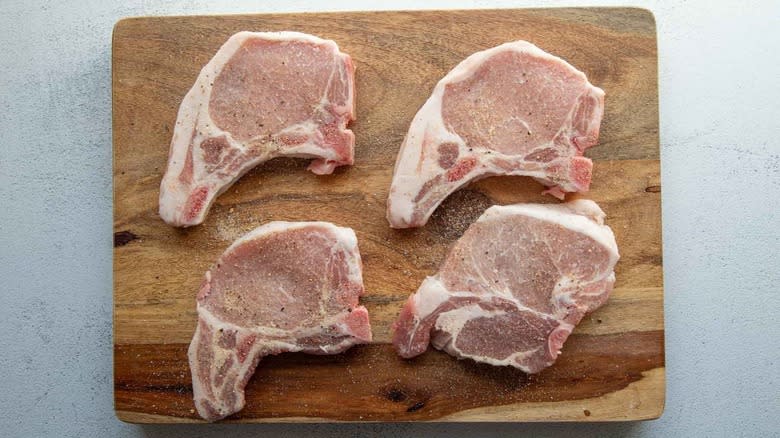 pork chops on wooden block