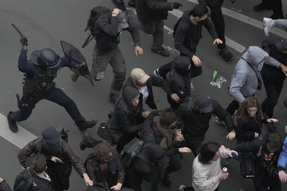 FILE - Riot police scuffle with protesters during a rally in Paris, on March 23, 2023. French authorities see the police as protectors ensuring that citizens can peacefully protest President Emmanuel Macron’s contentious retirement age increase. But to human rights advocates and demonstrators who were clubbed or tear-gassed, officers have overstepped their mission. (AP Photo/Christophe Ena, File)