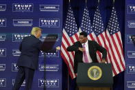 President Donald Trump elbow bumbs with Herschel Walker during a campaign rally, Friday, Sept. 25, 2020, in Atlanta. (AP Photo/John Bazemore)