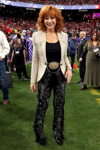 <p>Kevin Mazur/Getty </p> Reba McEntire performs at the 2024 Super Bowl