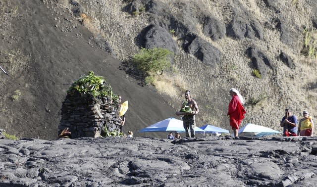 Native Hawaiian activists pray at the base of Hawaii’s Mauna Kea on Sunday