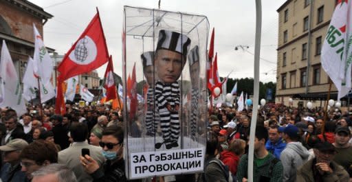 Opposition activists carry a carry a model of a prison cell with the cut-out figure of President Vladimir Putin during a rally in Saint-Petersburg last month. In just over two months since Vladimir Putin returned to the Kremlin, Russia's parliament has rushed through a flurry of legislation giving him new powers to crack down on the opposition movement