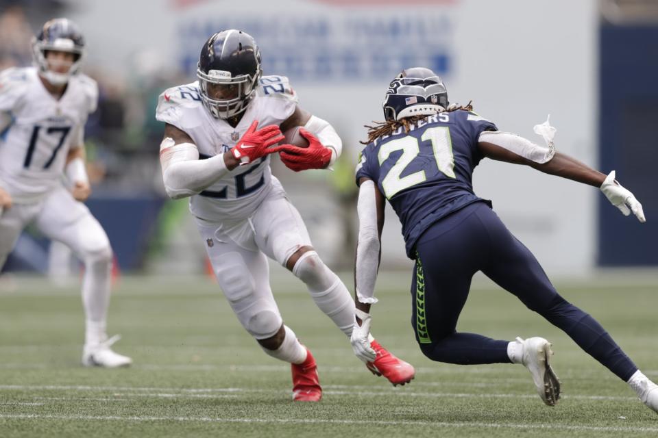 Tennessee Titans running back Derrick Henry evades Seattle Seahawks cornerback Tre Flowers.