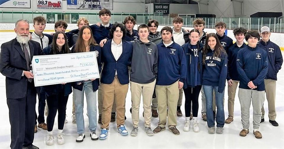 Members of the St. Thomas Aquinas boys and girls hockey teams present a check for $7,730 to Seacoast Cancer Center earlier this month. The money was raised during this year's annual Pink Game.