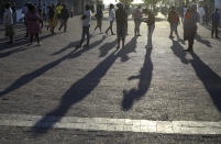 In this photo taken Thursday, April 2, 2020 people practice social distancing outside a testing clinic in Khayelitsha, Cape Town, South Africa. South Africa, one of the world's most unequal countries with a large population vulnerable to the new coronavirus, may have an advantage in the coronavirus outbreak, honed during years battling HIV and tuberculosis: the know-how and infrastructure to conduct mass testing. (AP Photo/Nardus Engelbrecht)