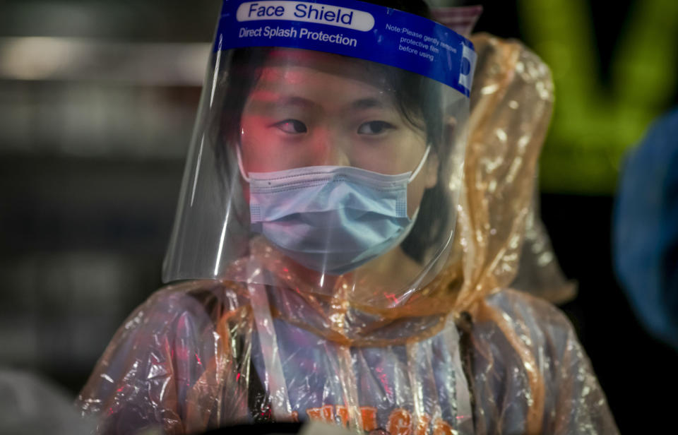 A Chinese tourist in from Shanghai, who arrived at Suvarnabhumi airport on a special tourist visa, walks, in Bangkok, Thailand, Tuesday, Oct. 20, 2020. Thailand on Tuesday took a modest step toward reviving its coronavirus-battered tourist industry by welcoming 39 visitors who flew in from Shanghai, the first such arrival since normal traveler arrivals were banned almost seven months ago. (AP Photo/Wason Wanichakorn)