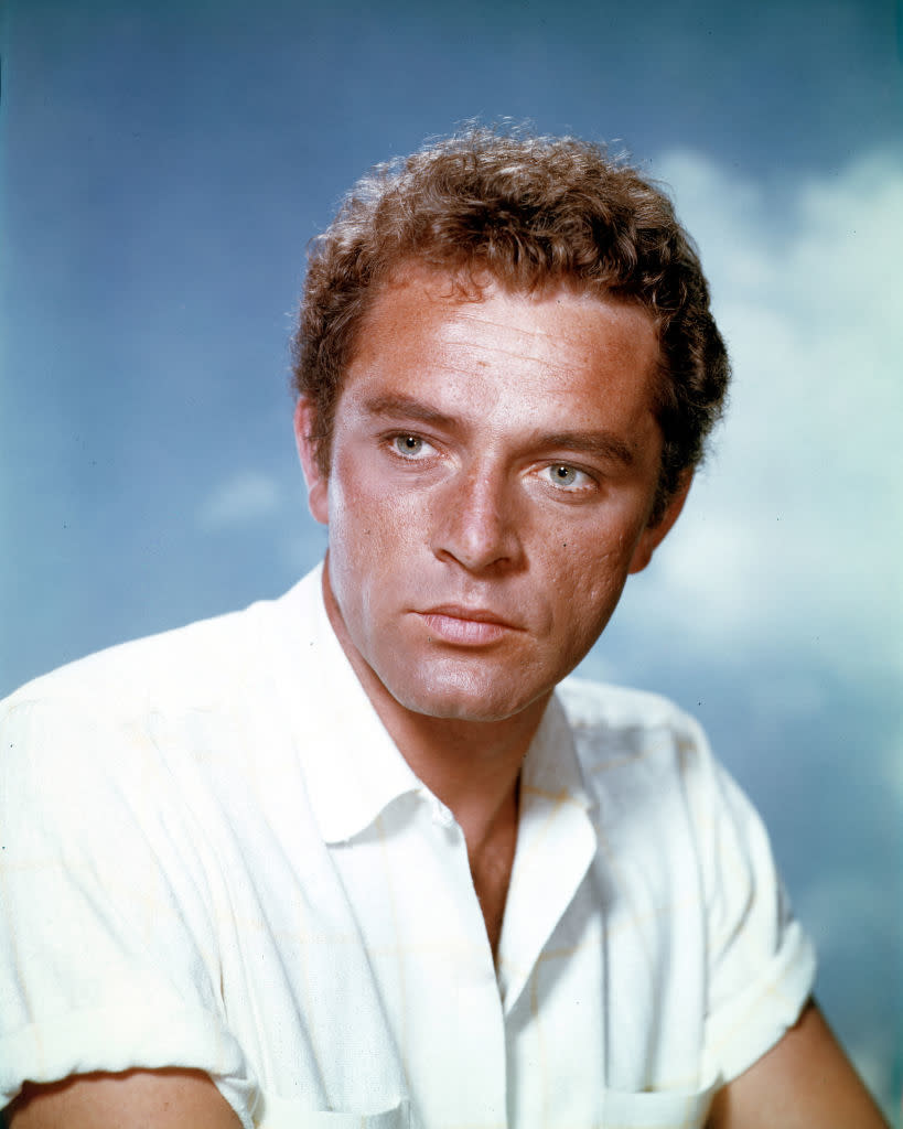 Richard Burton looks thoughtfully to the side wearing a white shirt