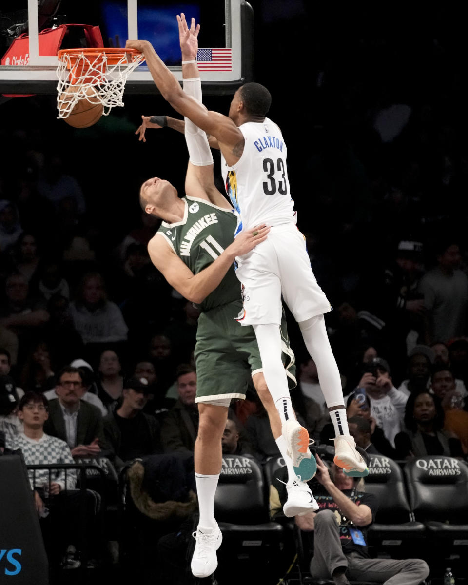 Brooklyn Nets center Nic Claxton (33) dunks over Milwaukee Bucks center Brook Lopez (11) during the second half of an NBA basketball game, Tuesday, Feb. 28, 2023, in New York. (AP Photo/John Minchillo)