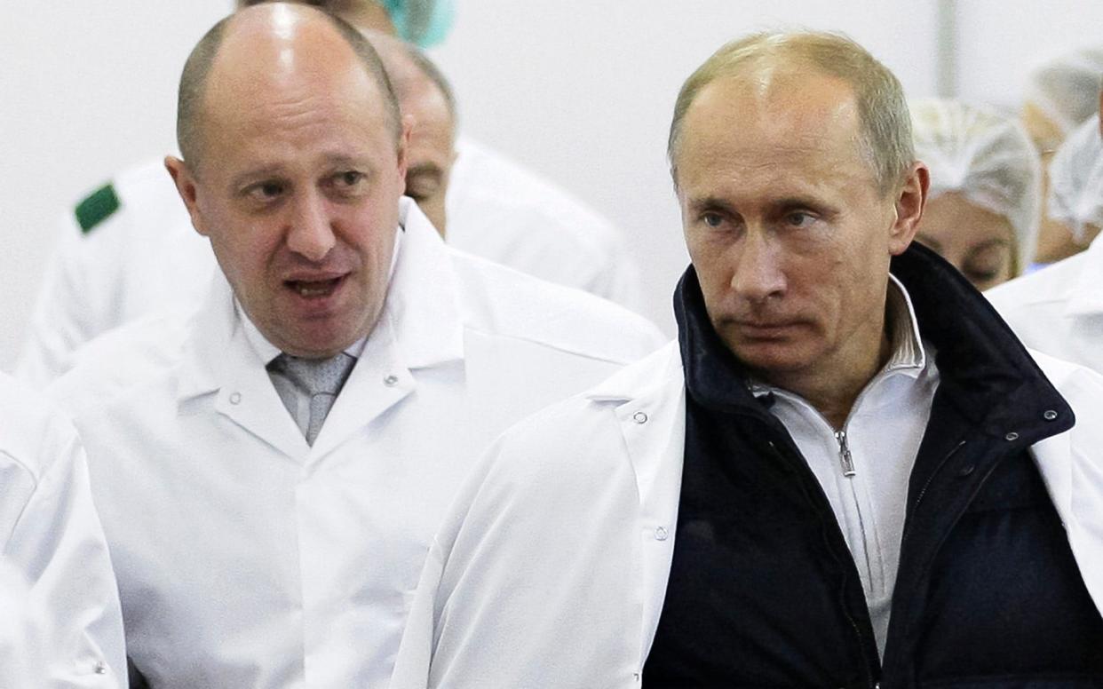 The campaign was attributed to sanctioned businessman Yevgeny Prigozhin, seen here showing Vladimir Putin a school lunch production facility in 2010 - POOL SPUTNIK KREMLIN