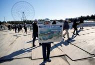 A man holds a conceptional drawing at the construction site of the Kasai Canoe Slalom Centre for Tokyo 2020 Olympic games in Tokyo, Japan February 12, 2019. REUTERS/Issei Kato