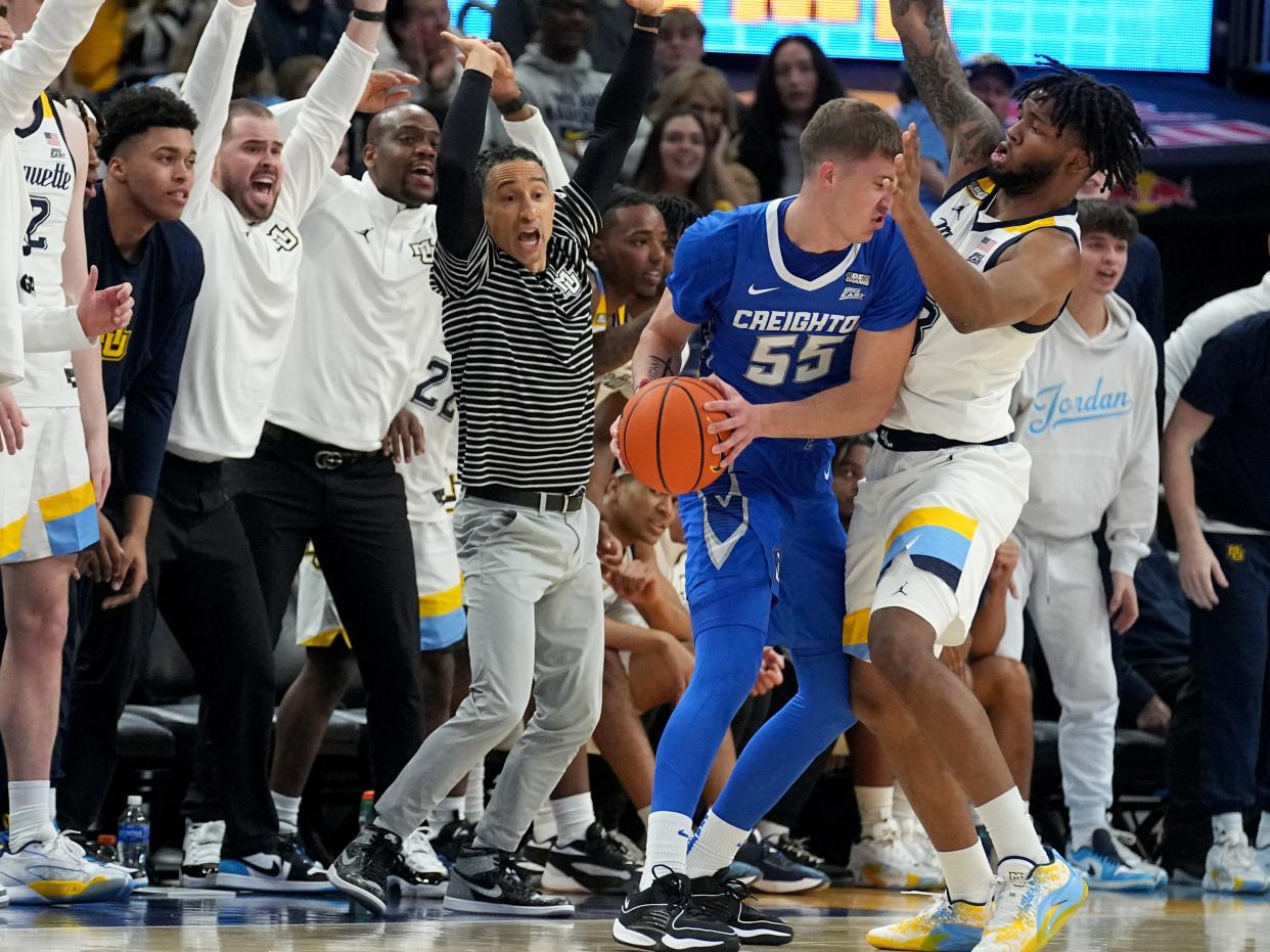 Marquette head coach Shaka Smart (striped shirt) yells while forward David Joplin (23) guards Creighton's Baylor Scheierman in the first half Saturday.