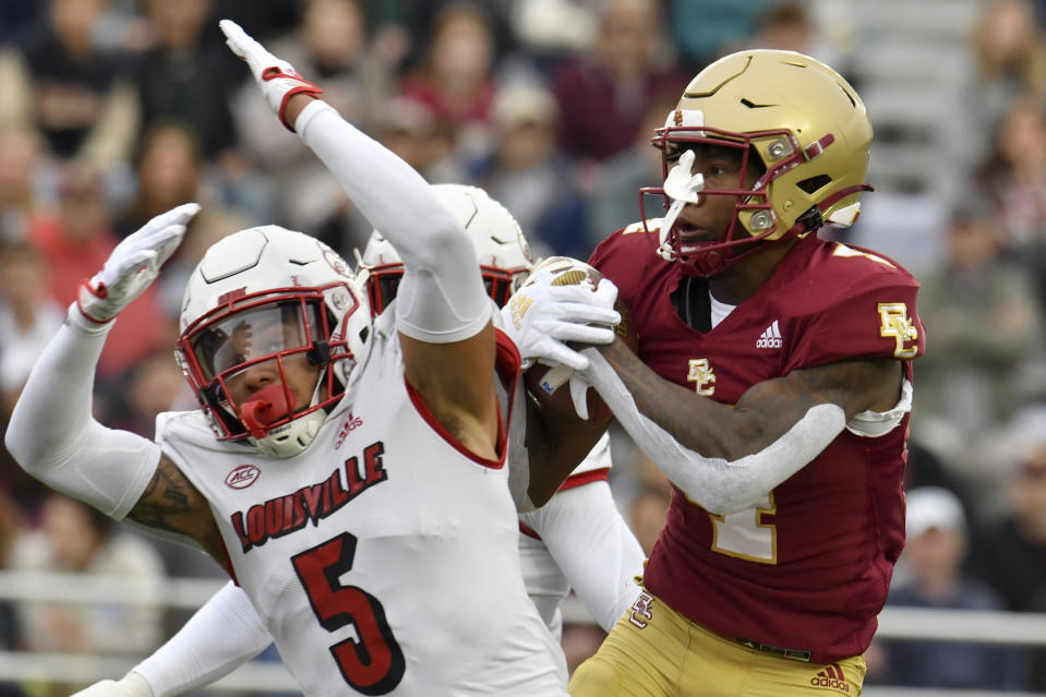 Boston College wide receiver Zay Flowers hauls in a pass despite the attempted breakup by Louisville's Josh Minkins during the first half of an NCAA college football game, Saturday, Oct. 1, 2022, in Boston. (AP Photo/Mark Stockwell)