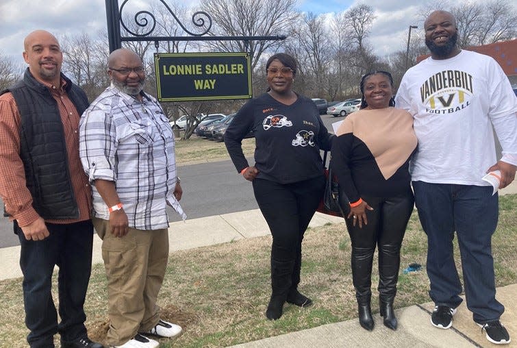 Lonnie Sadler's sons Kenta Sadler and Lonnie Sadler Jr., daughter Neece, wife Patricia and son Jason stand next to the street sign unveiled Wednesday in the former Madison High and Vanderbilt football star's honor. Lonnie Sadler died in 2020.