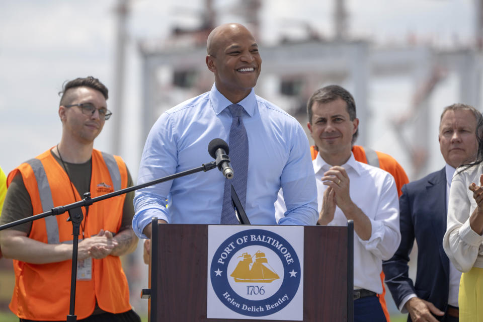 Maryland's Governor Wes Moore, second from left, speaks during a press conference to mark the full reopening of the Port of Baltimore after the collapse of the Francis Scott Key Bridge in March, Wednesday, June 12, 2024, at the Port of Baltimore in Dundalk, Md. (AP Photo/Mark Schiefelbein)