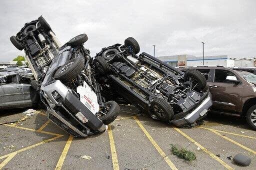 New cars pictured upside down on top of each other after the tornado. 