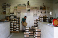 <p>A farmworker stacks boxes of wine for sale at the Vergenoegd wine estate near Cape Town, South Africa, May 20, 2016. (REUTERS/Mike Hutchings) </p>