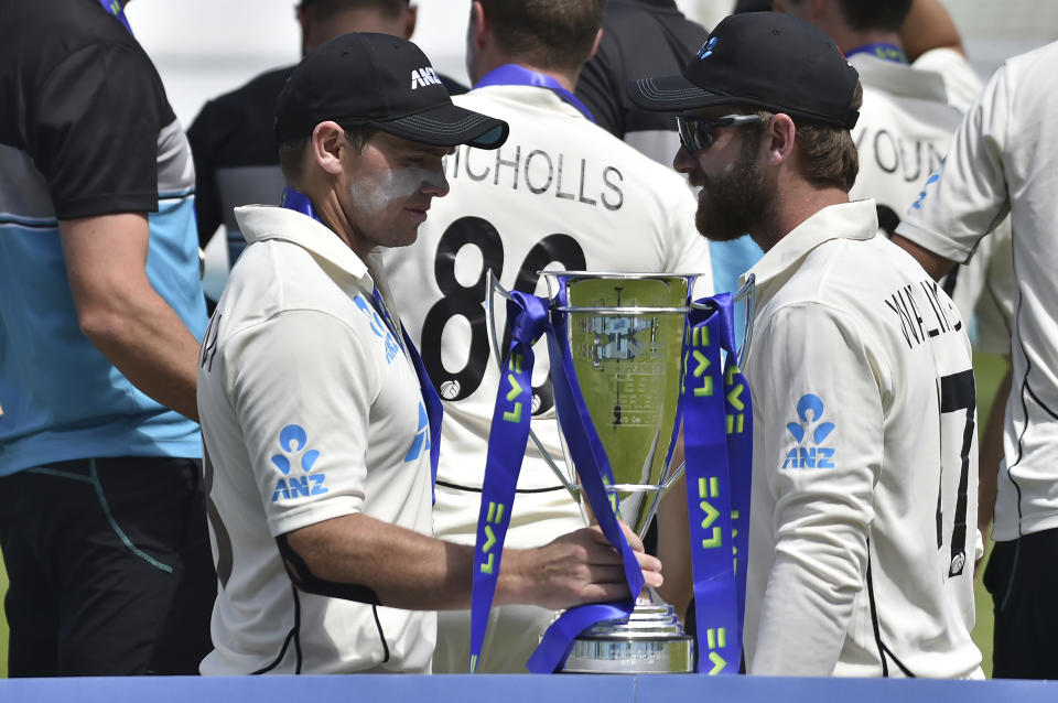 New Zealand's Tom Latham, left, holds the winners trophy as he stands with teammate Kane Williamson after their win in the second cricket test match against England at Edgbaston in Birmingham, England, Sunday, June 13, 2021. New Zealand won the series 1-0. (AP Photo/Rui Vieira)