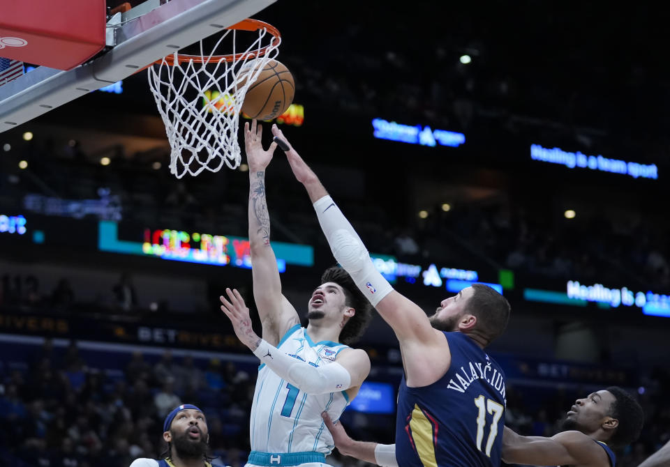 Charlotte Hornets guard LaMelo Ball (1) goes to the basket against New Orleans Pelicans center Jonas Valanciunas (17) in the first half of an NBA basketball game in New Orleans, Wednesday, Jan. 17, 2024. (AP Photo/Gerald Herbert)
