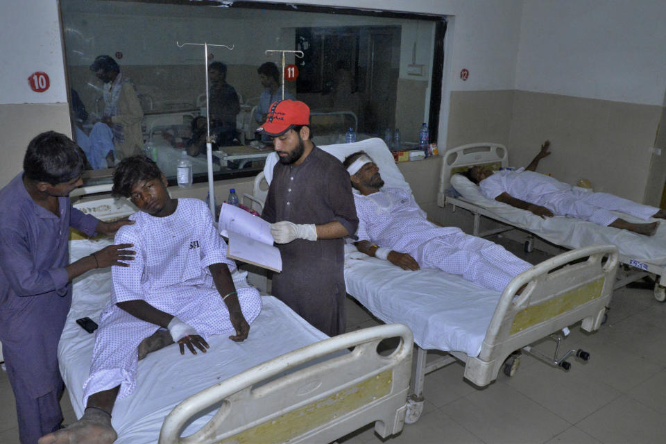 Injured victims of a passenger train derailed incident, are treated at a hospital, in Nawabshah, Pakistan, Sunday, Aug. 6, 2023. Railway officials say some passengers were killed and dozens more injured when a train derailed near the town of Nawabshah in southern Sindh province. (AP Photo/Pervez Masih)