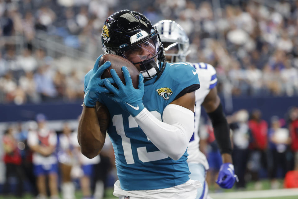 Jacksonville Jaguars wide receiver Christian Kirk (13) scores a touchdown during the first half of an NFL preseason football game against the Dallas Cowboys, Saturday, Aug. 12, 2023, in Arlington, Texas. (AP Photo/Michael Ainsworth)
