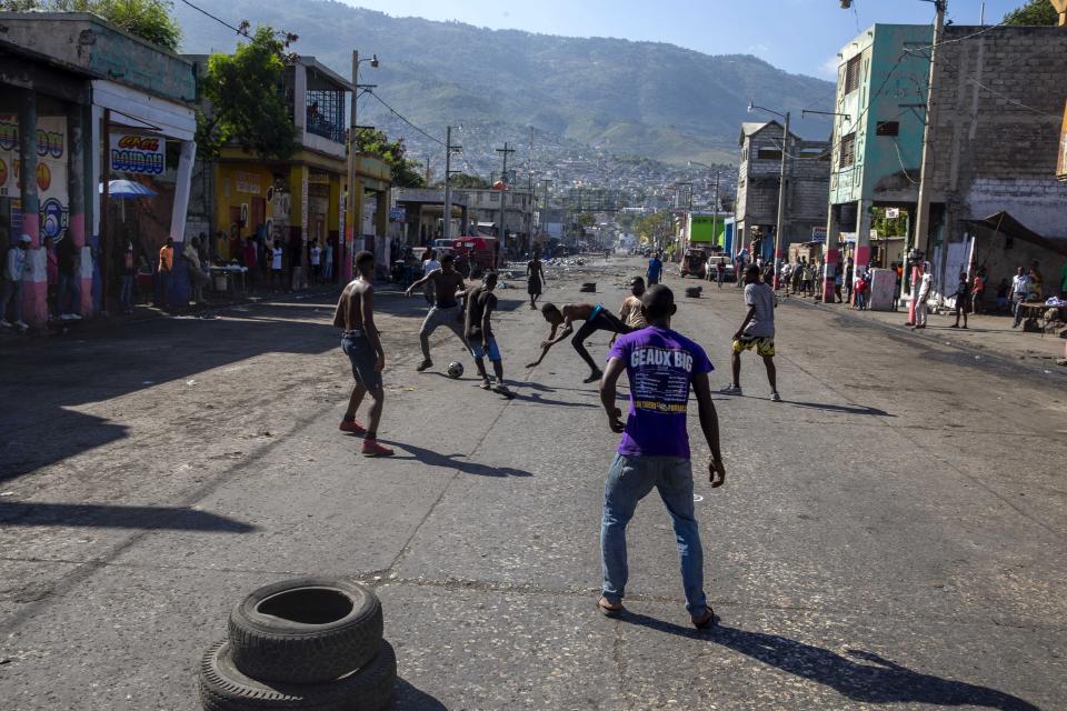 People play soccer in a street left empty by a nationwide strike demanding the resignation of Haitian President Jovenel Moise in Port-au-Prince, Haiti, Monday, Feb. 1, 2021. (AP Photo/Dieu Nalio Chery)