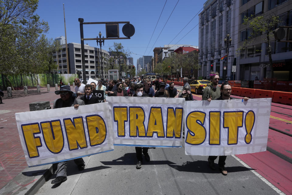 Protesters carry signs during a "funeral for public transit" march in San Francisco, Saturday, June 3, 2023. California's public transit agencies say they are running out of money, plagued by depleted ridership from the pandemic and soon-to-expire federal aid. But California's state government is having its own financial problems, leaving the fate of public transit agencies uncertain in this car-obsessed state. (AP Photo/Jeff Chiu)