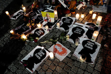 Candles and placards are pictured during a protest in support of Alfie Evans, in front of the British embassy building in Warsaw, Poland April 26, 2018. REUTERS/Kacper Pempel