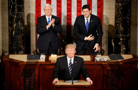 U.S. President Trump addresses Joint Session of Congress - Washington, U.S. - 28/02/17 - U.S. President Donald Trump pauses as he speaks in front of Vice President Mike Pence (L) and Speaker of the House Paul Ryan. REUTERS/Jim Bourg