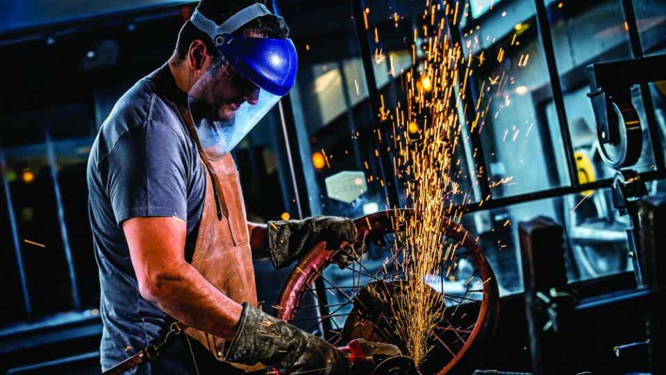 Bueno cutting out the rusted array of spokes on the 1929 Majestic before replacing them with ones made from more wear-resistant metal.