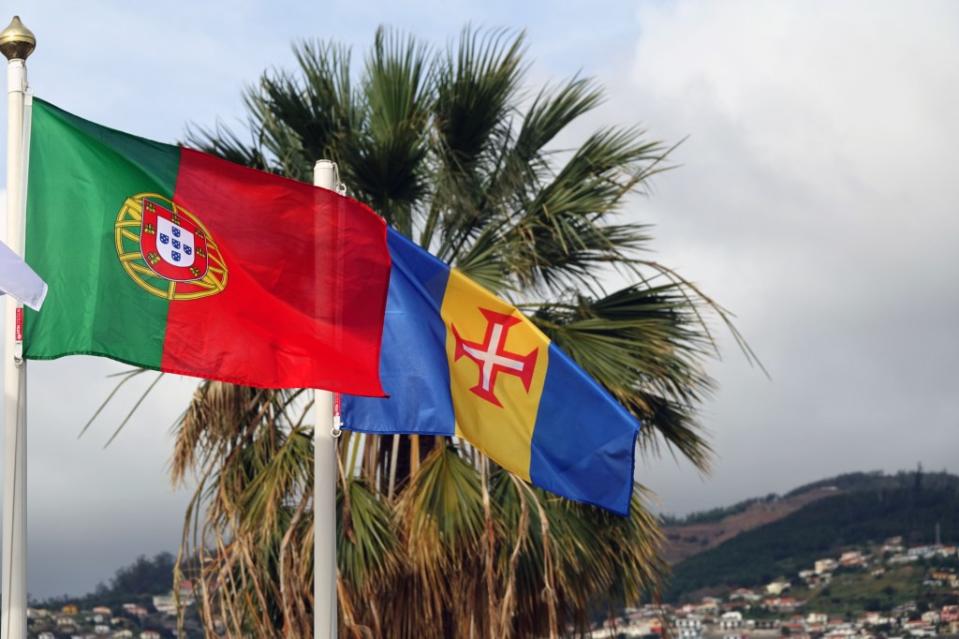 Wave hello! The Madeiran and Portuguese flags pair well together. Shutterstock